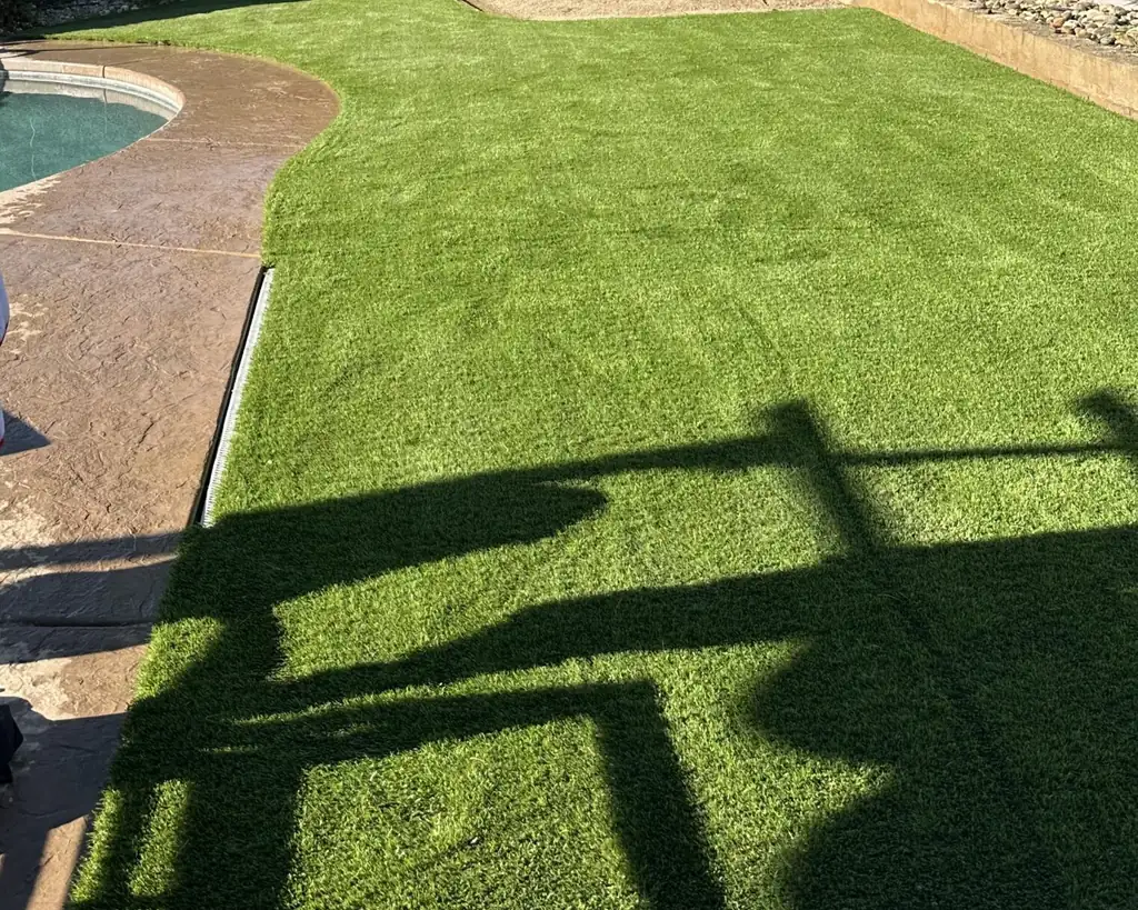 Poolside artificial grass installation